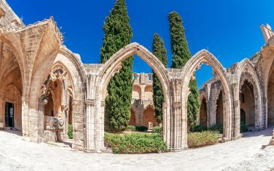 Wide angle panoramic image of the ancient arches of a ruined Bellapais monastery