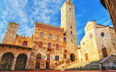 Picturesque View of famous Piazza del Duomo in San Gimignano at sunset, Tuscany, Italy